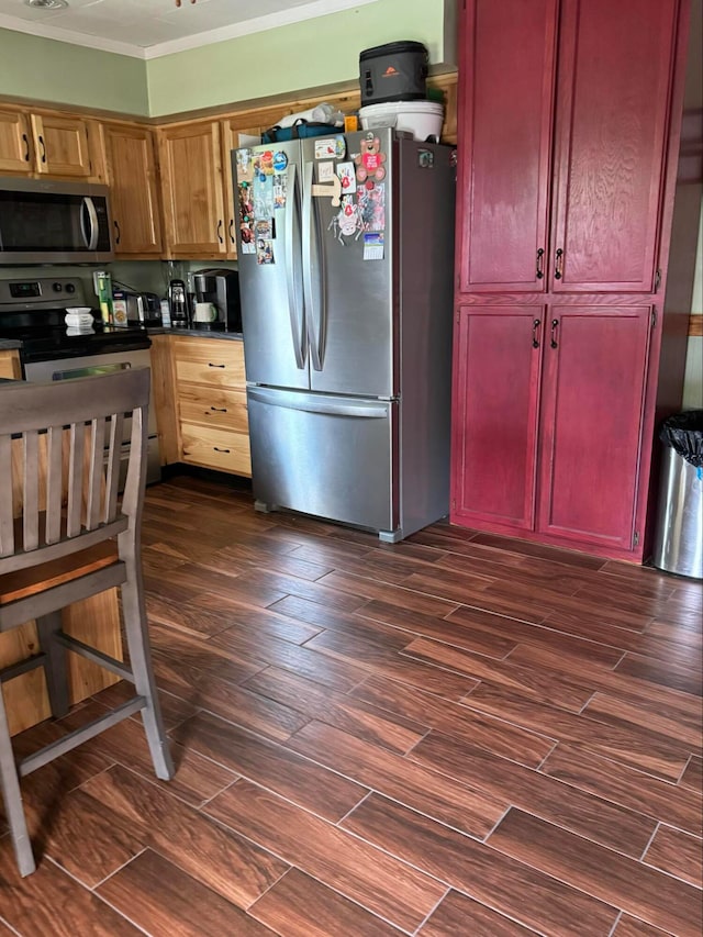 kitchen featuring appliances with stainless steel finishes and crown molding