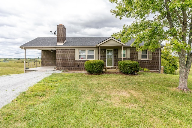 ranch-style home with a carport and a front lawn