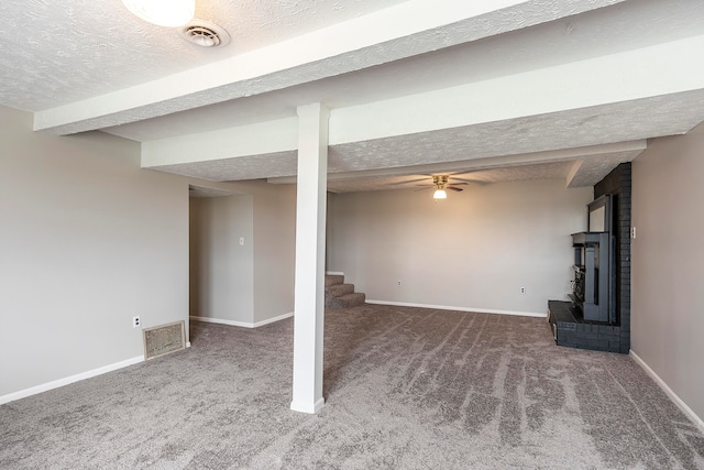 basement with a textured ceiling and carpet flooring