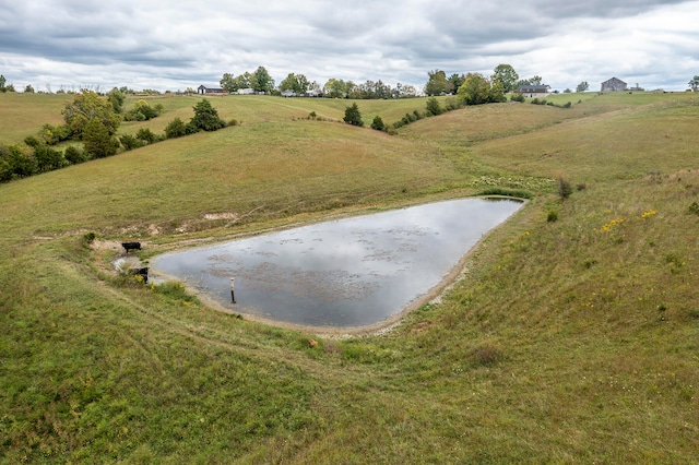 birds eye view of property with a water view and a rural view