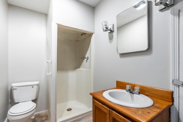 bathroom with walk in shower, vanity, and toilet