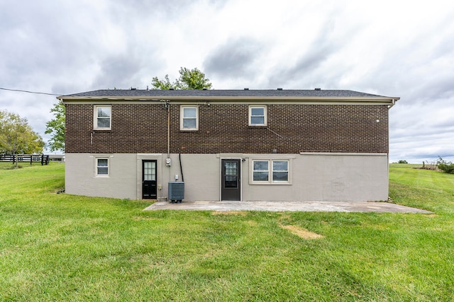 back of house with a lawn, cooling unit, and a patio area