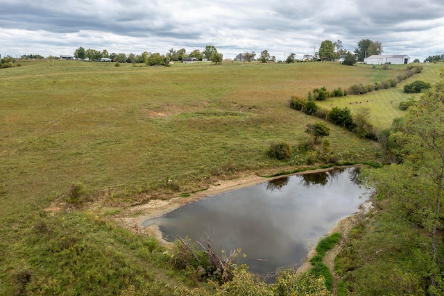 birds eye view of property with a water view and a rural view