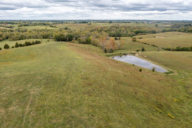 birds eye view of property featuring a water view and a rural view