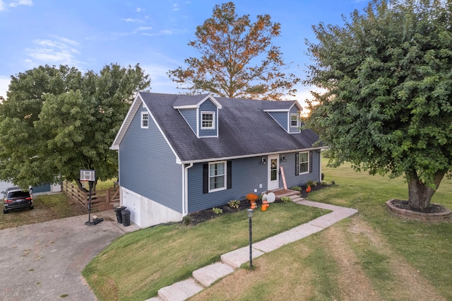 cape cod-style house featuring a front lawn