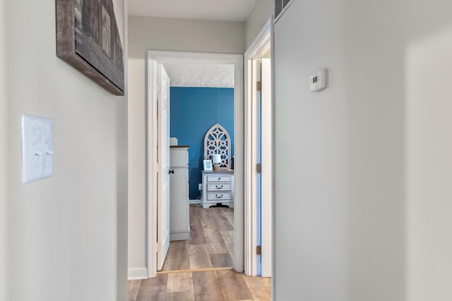 hall with light hardwood / wood-style floors