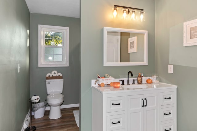 bathroom featuring vanity, toilet, and hardwood / wood-style flooring