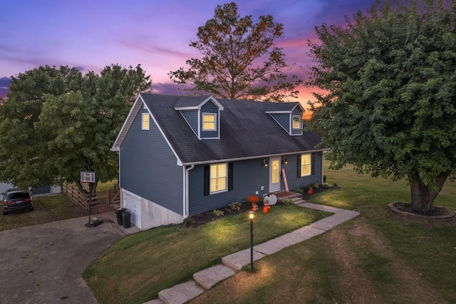 cape cod house with a lawn