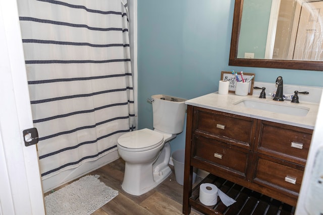 bathroom featuring vanity, toilet, a shower with shower curtain, and hardwood / wood-style flooring