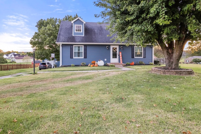 cape cod home with a front lawn