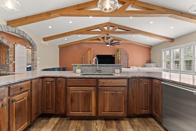 kitchen featuring sink, stainless steel dishwasher, dark wood-type flooring, lofted ceiling with beams, and a barn door