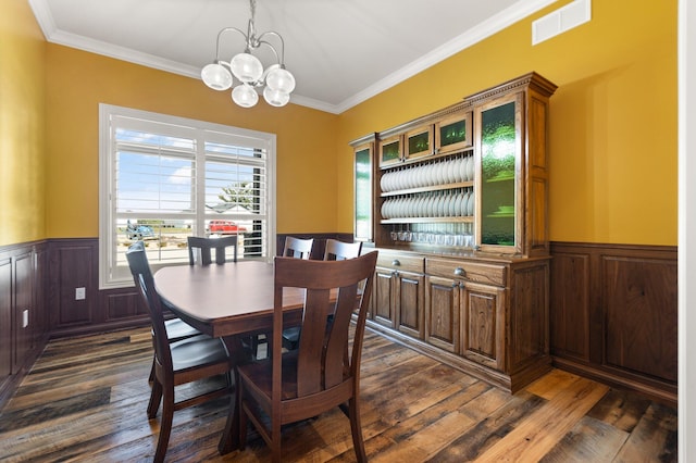 dining room featuring a chandelier, crown molding, and dark hardwood / wood-style flooring