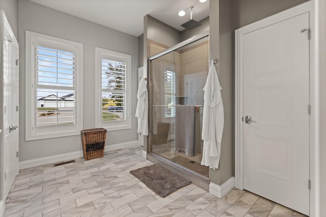 bathroom with a shower with door