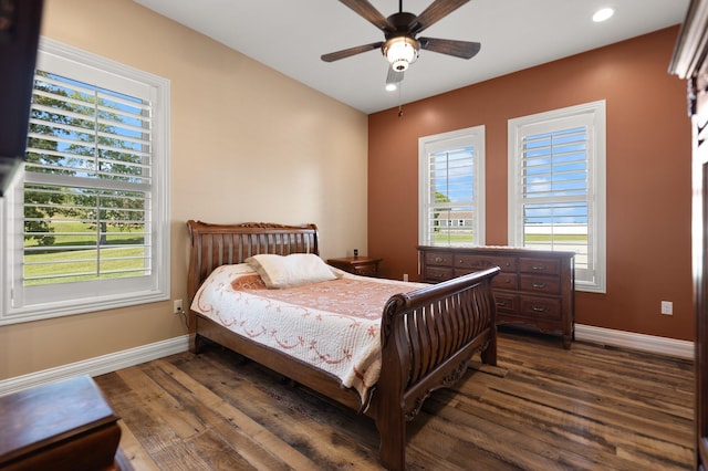 bedroom with multiple windows, dark wood-type flooring, and ceiling fan