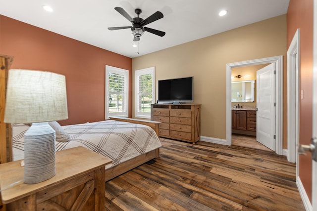 bedroom with ceiling fan, dark hardwood / wood-style floors, and ensuite bathroom