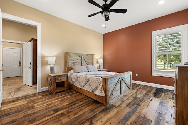 bedroom with ceiling fan and dark hardwood / wood-style floors