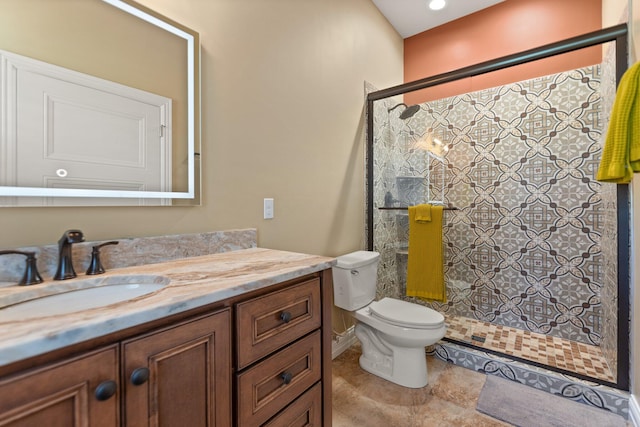 bathroom featuring tile patterned floors, walk in shower, vanity, and toilet