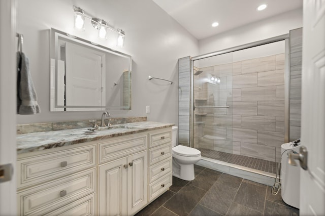 bathroom with walk in shower, vanity, and toilet