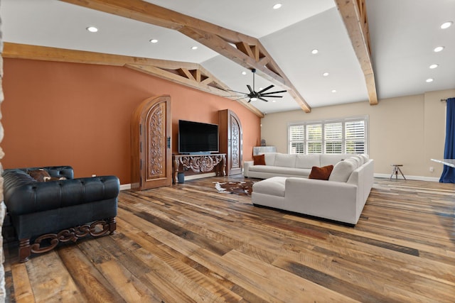 living room featuring ceiling fan, lofted ceiling with beams, and hardwood / wood-style floors