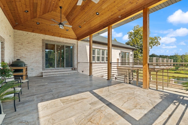 view of patio featuring a water view and ceiling fan