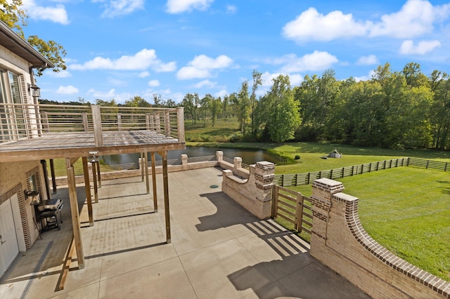 view of patio featuring a water view and an outdoor fire pit