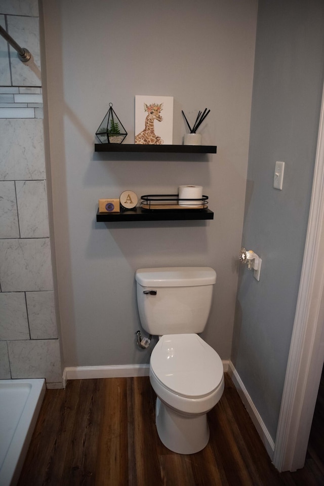 bathroom with walk in shower, hardwood / wood-style floors, and toilet