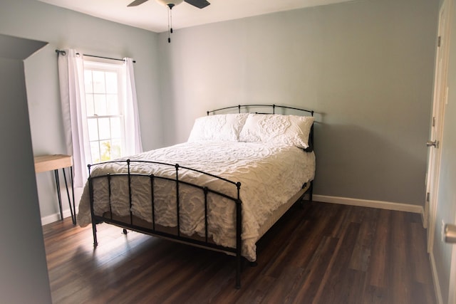 bedroom featuring dark hardwood / wood-style flooring and ceiling fan