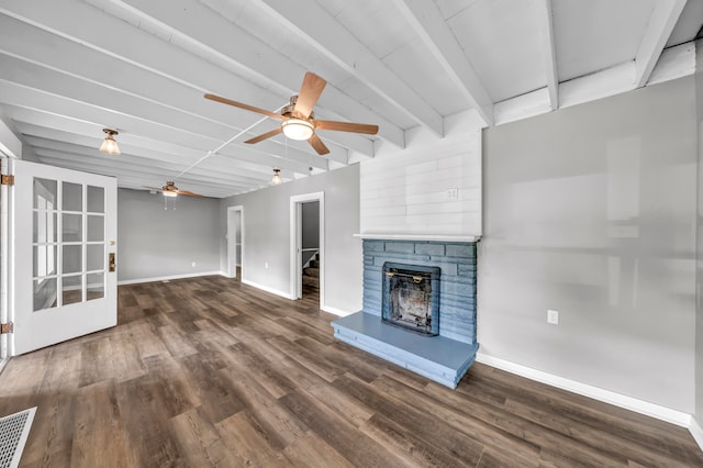 unfurnished living room featuring ceiling fan, a fireplace, beam ceiling, and dark wood-type flooring