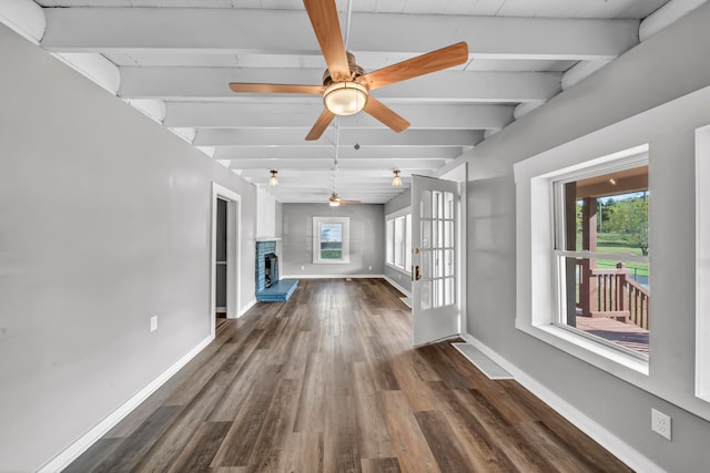 unfurnished living room with ceiling fan, beamed ceiling, dark hardwood / wood-style floors, and french doors