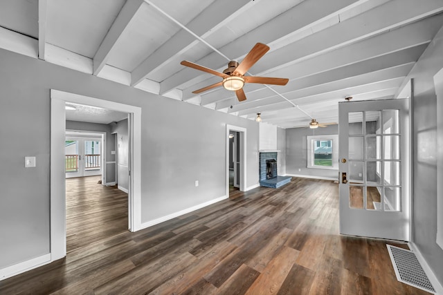 unfurnished living room featuring ceiling fan, plenty of natural light, and dark hardwood / wood-style floors