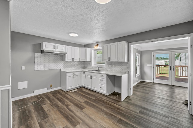 kitchen featuring a textured ceiling, dark hardwood / wood-style flooring, and white cabinetry