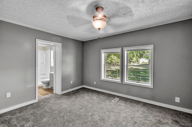 spare room with a textured ceiling, carpet, and ceiling fan