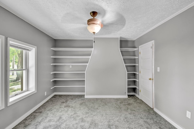 spacious closet featuring ceiling fan and light colored carpet