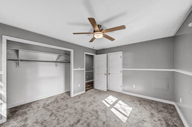 unfurnished bedroom with ceiling fan, a textured ceiling, and light carpet