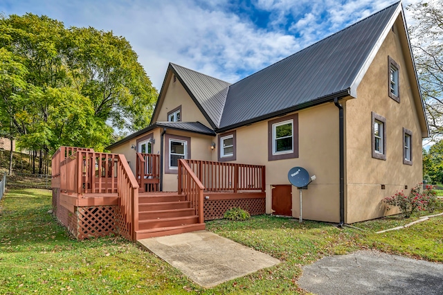 back of house with a lawn and a deck