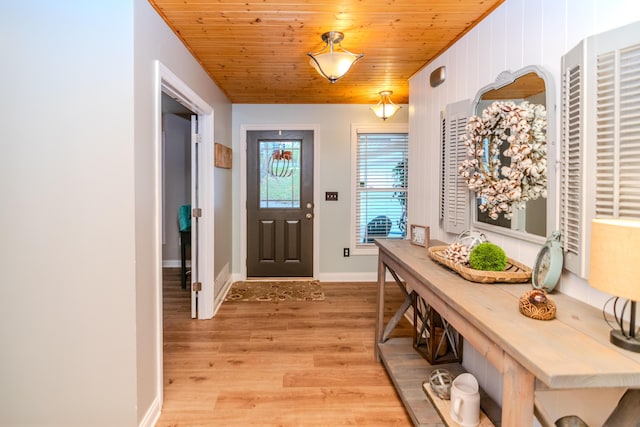 doorway to outside with light hardwood / wood-style floors and wooden ceiling