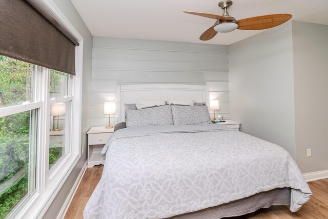 bedroom with ceiling fan and light wood-type flooring