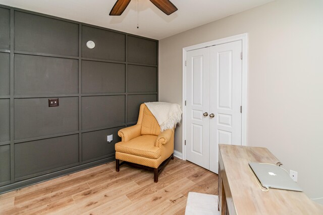 bedroom featuring light wood-type flooring, ceiling fan, a walk in closet, and a closet