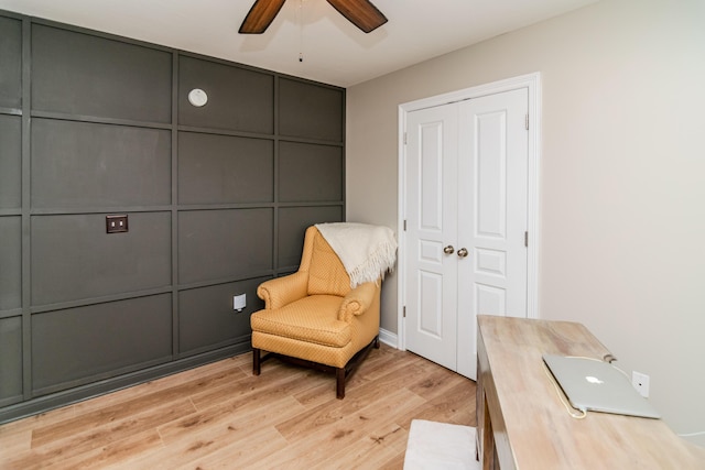 living area with light hardwood / wood-style flooring and ceiling fan