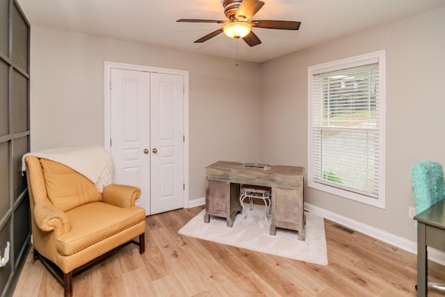 home office featuring light hardwood / wood-style flooring and ceiling fan