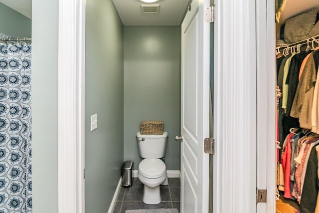 bathroom featuring tile patterned flooring and toilet