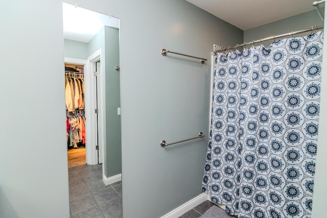 bathroom with tile patterned floors and walk in shower