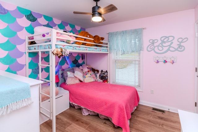 bedroom with hardwood / wood-style floors and ceiling fan