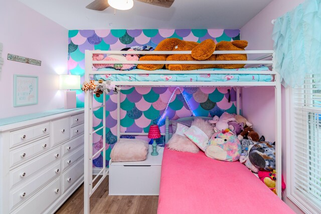 bedroom with ceiling fan and hardwood / wood-style flooring