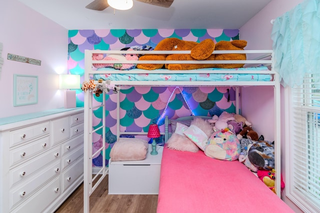 bedroom with light hardwood / wood-style floors and ceiling fan