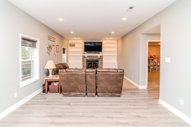 kitchen featuring light stone counters, sink, white cabinetry, light hardwood / wood-style flooring, and stainless steel appliances