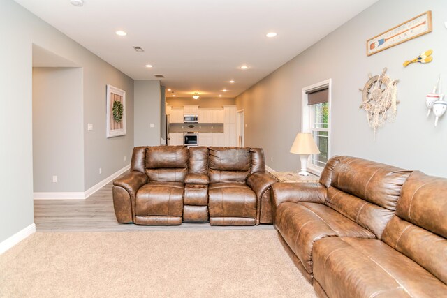 living room with carpet and a fireplace