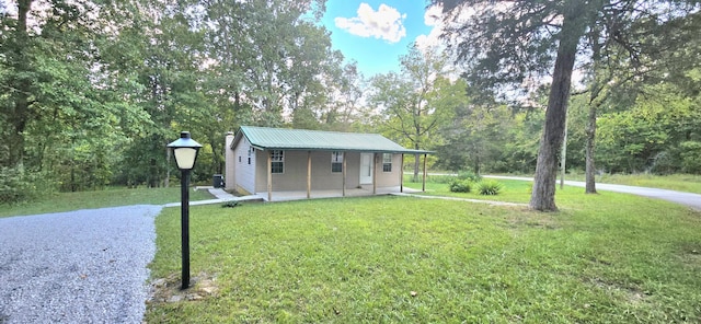 1835 Echo Point Rd, Bronston, KY 42518 - view of front of property with a front lawn, metal roof, and view of scattered trees