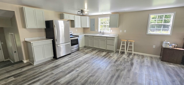 1835 Echo Point Rd, Bronston, KY 42518 - kitchen featuring stainless steel appliances, wood finished floors, a sink, light countertops, and baseboards