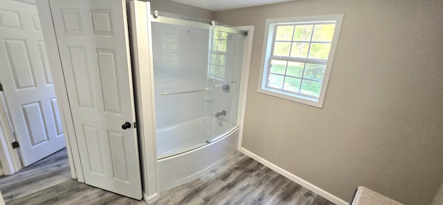 1835 Echo Point Rd, Bronston, KY 42518 - full bath with baseboards, wood finished floors, bathing tub / shower combination, and plenty of natural light